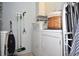 Functional laundry room with washer, dryer, and storage at 5565 Salem Square N Dr, Palm Harbor, FL 34685