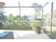 Serene screened porch with water view and lush greenery at 5565 Salem Square N Dr, Palm Harbor, FL 34685