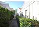 Neat walkway between homes with lush landscaping at 5565 Salem Square N Dr, Palm Harbor, FL 34685