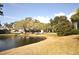 Peaceful waterfront view of community homes and landscape at 5565 Salem Square N Dr, Palm Harbor, FL 34685