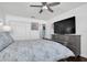 Spacious bedroom with large TV, dresser, and ceiling fan at 5623 80Th N St # 505, St Petersburg, FL 33709