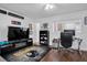 A sports themed room with dark wood floors, a ceiling fan, Steelers rug, and a desk area at 5623 80Th N St # 505, St Petersburg, FL 33709