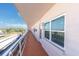 An exterior view of a condo's exterior with a hallway and a view to the outside at 5623 80Th N St # 505, St Petersburg, FL 33709