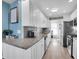 A modern kitchen featuring white cabinets, stainless steel appliances, and stylish gray tile backsplash at 5623 80Th N St # 505, St Petersburg, FL 33709