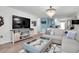 Living room with sectional sofa, large TV, and rustic media console at 5623 80Th N St # 505, St Petersburg, FL 33709
