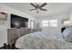 A well-lit bedroom featuring wood-look floors, a ceiling fan, and comfortable furnishings at 5623 80Th N St # 505, St Petersburg, FL 33709