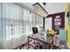 Sunlit office space showcasing a workspace with a vibrant rug and eclectic style at 5623 80Th N St # 505, St Petersburg, FL 33709
