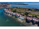 Stunning aerial view of a waterfront condominium complex showcasing the water, surrounding landscape and golf course at 5633 Puerta Del Sol S Blvd # 306, St Petersburg, FL 33715