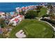 Stunning aerial view of property showcasing the golf course, waterfront, pool, and lush landscaping at 5633 Puerta Del Sol S Blvd # 306, St Petersburg, FL 33715