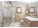 Classic bathroom with a shower-tub combination, framed palm tree art, and a vanity, blending comfort with timeless style at 5633 Puerta Del Sol S Blvd # 306, St Petersburg, FL 33715