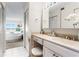 Bright bathroom featuring a vanity with a built-in makeup table, complemented by a bedroom with a stunning water view at 5633 Puerta Del Sol S Blvd # 306, St Petersburg, FL 33715