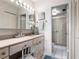 Well-lit bathroom featuring a shower stall, vanity, and neutral decor at 5633 Puerta Del Sol S Blvd # 306, St Petersburg, FL 33715