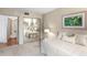 Inviting bedroom featuring a mirrored closet, and an ensuite bathroom in the background, creating a serene and private retreat at 5633 Puerta Del Sol S Blvd # 306, St Petersburg, FL 33715
