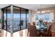Bright dining area features modern chandelier, glass table with six chairs, and balcony access at 5633 Puerta Del Sol S Blvd # 306, St Petersburg, FL 33715