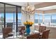 Dining area showing chandelier and glass table with six chairs leading to a balcony with beautiful views at 5633 Puerta Del Sol S Blvd # 306, St Petersburg, FL 33715