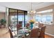 Dining area featuring a modern chandelier and a glass table with seating for six near balcony at 5633 Puerta Del Sol S Blvd # 306, St Petersburg, FL 33715