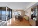 Dining room with a modern chandelier, hardwood floors and a glass table that seats six at 5633 Puerta Del Sol S Blvd # 306, St Petersburg, FL 33715