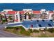 Exterior showcasing the parking, lush landscaping, and beautiful multi-story condominium building at 5633 Puerta Del Sol S Blvd # 306, St Petersburg, FL 33715