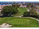 Scenic golf course view with lush green fairways, mature trees, and waterfront residences in the background at 5633 Puerta Del Sol S Blvd # 306, St Petersburg, FL 33715