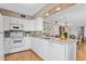Well-lit kitchen boasts white cabinetry, granite countertops, and modern stainless steel appliances at 5633 Puerta Del Sol S Blvd # 306, St Petersburg, FL 33715
