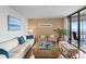 Inviting living room featuring a comfortable sofa, stylish decor, and sliding doors to a balcony with water views at 5633 Puerta Del Sol S Blvd # 306, St Petersburg, FL 33715