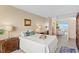 Bright main bedroom showing ensuite bathroom, neutral walls, and beautiful views at 5633 Puerta Del Sol S Blvd # 306, St Petersburg, FL 33715