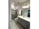 Bathroom featuring a glass shower, quartz countertop, and a contemporary vanity at 6035 Plover Meadow St, Lithia, FL 33547