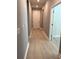 Bright hallway with light gray walls and wood-look flooring at 6035 Plover Meadow St, Lithia, FL 33547
