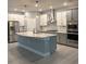 Modern kitchen featuring stainless steel appliances, an island, and two-tone cabinets at 6035 Plover Meadow St, Lithia, FL 33547