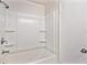 Bathroom with shower/tub combo and shelving at 7202 N 21St St, Tampa, FL 33610