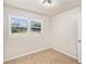 Well-lit bedroom with tile floors and two windows at 7202 N 21St St, Tampa, FL 33610