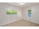 Bright bedroom with tile flooring and two windows at 7202 N 21St St, Tampa, FL 33610