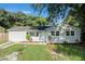 Newly renovated light gray house with a spacious lawn at 7202 N 21St St, Tampa, FL 33610