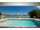 Inviting swimming pool with clear water and waterfront view at 817 Bay Point Dr, Madeira Beach, FL 33708