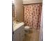 Bathroom with floral shower curtain and white vanity at 8615 Mallard Reserve Dr # 102, Tampa, FL 33614