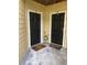 Two condo unit entry doors with welcome mats at 8615 Mallard Reserve Dr # 102, Tampa, FL 33614