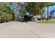 House with spacious paved driveway and surrounding trees at 931 And 925 Florida Ave, Palm Harbor, FL 34683