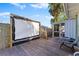 Wooden deck with a projector screen and seating at 931 And 925 Florida Ave, Palm Harbor, FL 34683