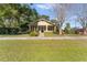 Charming house with a green door and well-manicured lawn at 931 And 925 Florida Ave, Palm Harbor, FL 34683
