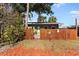 House exterior featuring a green wood fence and small patio at 931 And 925 Florida Ave, Palm Harbor, FL 34683