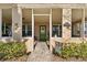 House entrance with green door, screened porch, and walkway at 931 And 925 Florida Ave, Palm Harbor, FL 34683