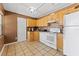 Cozy kitchen with light wood cabinets and white appliances at 931 And 925 Florida Ave, Palm Harbor, FL 34683