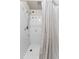 Clean shower stall with tiled walls and a shower curtain at 931 And 925 Florida Ave, Palm Harbor, FL 34683