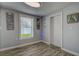 Bright living room featuring wood-look floors and a large window with natural light at 9441 56Th N Way, Pinellas Park, FL 33782