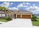 Two-story house with three-car garage and a stone facade at 1030 Tracey Ann Loop, Seffner, FL 33584