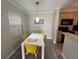 Bright dining area with a table and four yellow chairs at 107 S Obrien St # 220, Tampa, FL 33609