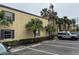 Condo building exterior showcasing parking and landscaping at 107 S Obrien St # 220, Tampa, FL 33609