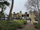 Condo building with parking lot and lush landscaping at 107 S Obrien St # 220, Tampa, FL 33609