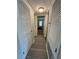Long hallway with light wood-look flooring and neutral walls at 107 S Obrien St # 220, Tampa, FL 33609