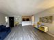 Open living area with gray flooring and access to a balcony at 107 S Obrien St # 220, Tampa, FL 33609